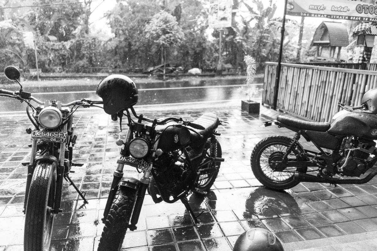 Motorcycles in the rain requiring riders to wear rain gear