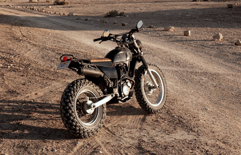 Scrambler motorcycle on a dirt lane