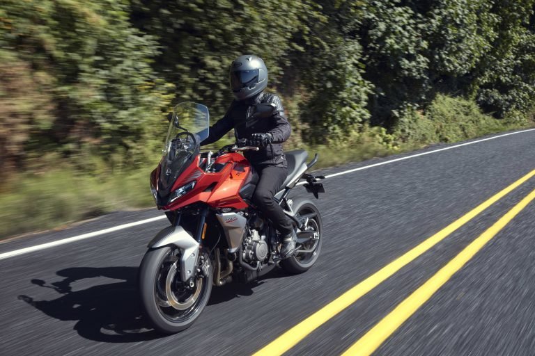 2022 Triumph Tiger Sport 660 riding on a two-lane highway