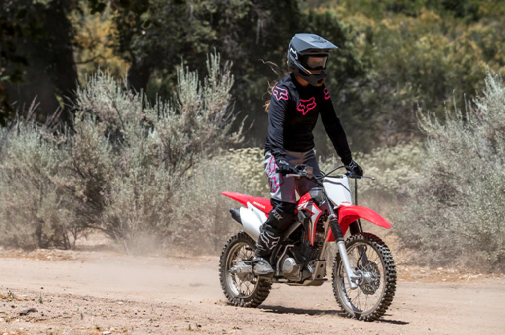 A rider on a Honda CRF 125 F on a dirt track. 