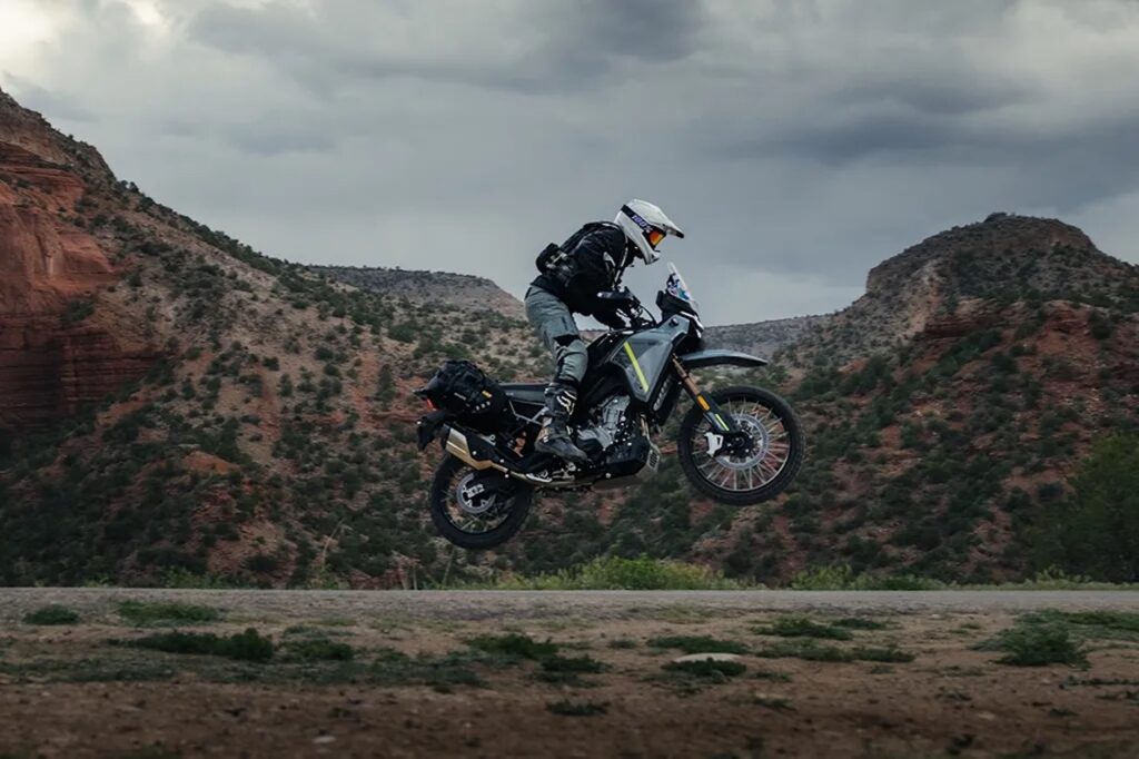 A CFMOTO Ibex 450 jumping off road.