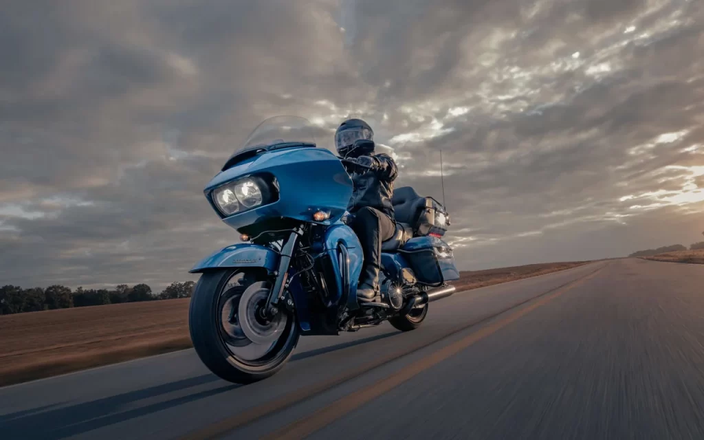 A man riding a Harley-Davidson Road Glide Limited on a two lane highway