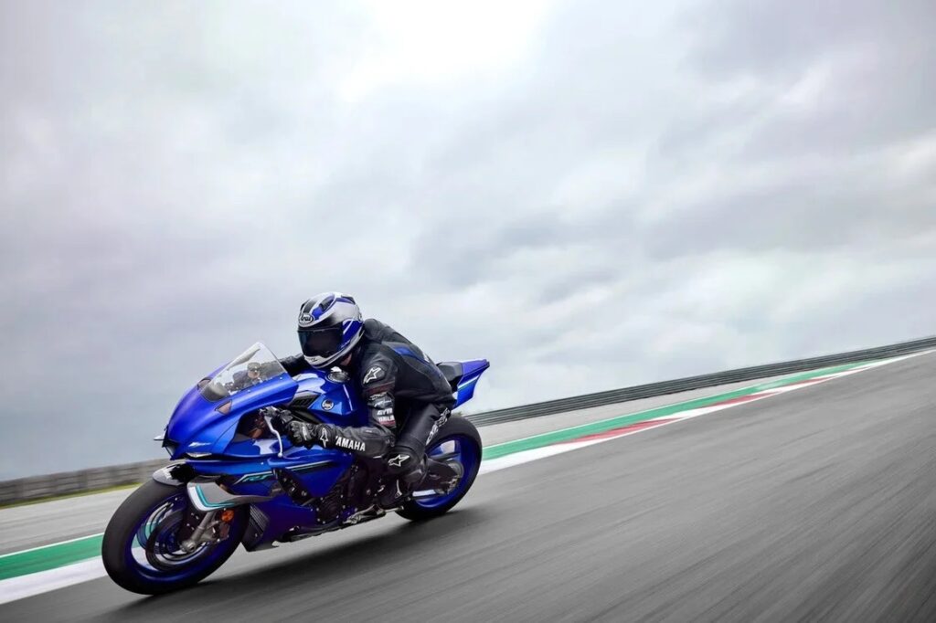 Yamaha YZF-R1 sportbike taking a turn at a race track. 