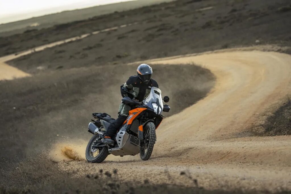 2025 KTM 790 Adventure on a curvy dirt road.