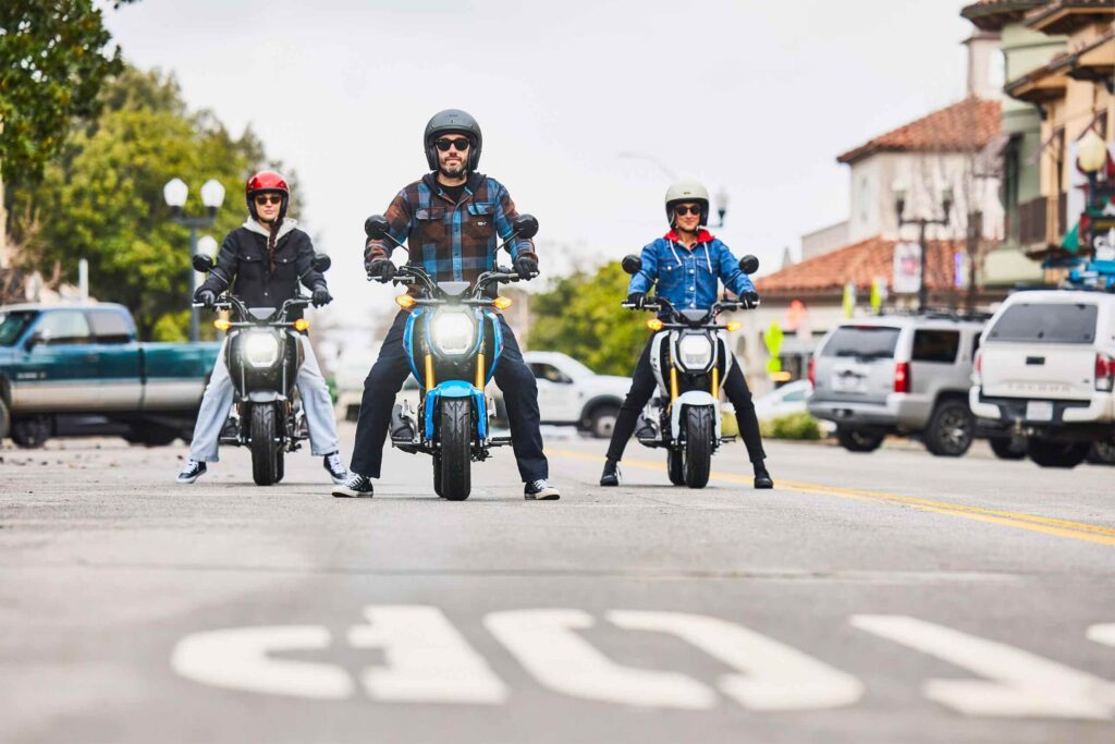 motorcyclists on three honda grom motorcycles