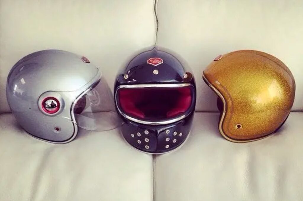 Three helmets from Ateliers Ruby sitting on a leather backdrop.