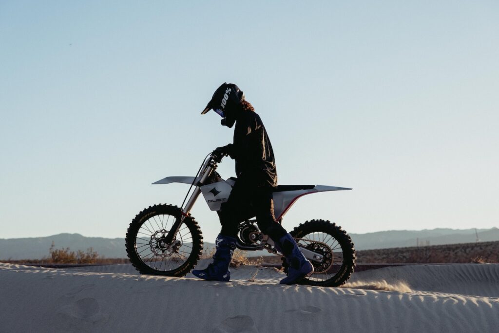 A rider standing next to the Dust Moto Hightail