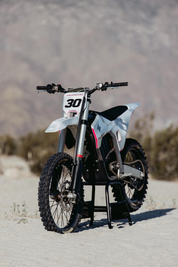The Dust Moto Hightail electric dirt bike on a bike stand.
