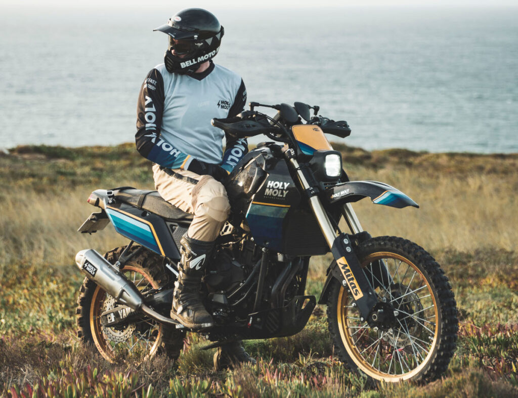 Retro Custom Yamaha T7 by Holy Moly Motorcycles parked in a field