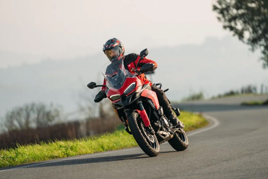 The 2025 Ducati Multistrada V2 riding on an Italian road.