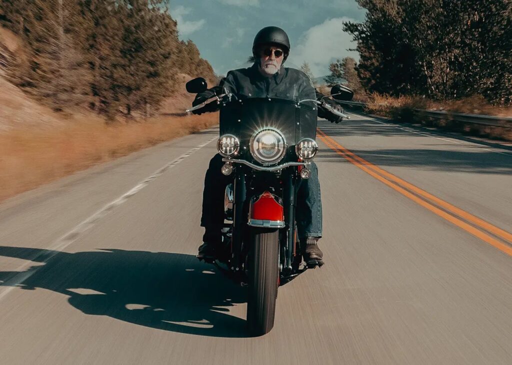 A man riding the 2025 Harley-Davidson Softail Heritage model on a highway