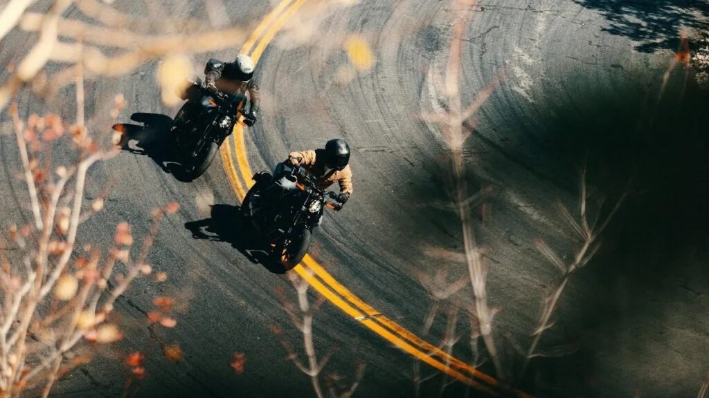 Two 2025 LiveWire S2 Alpinista electric motorcycles riding around a curve