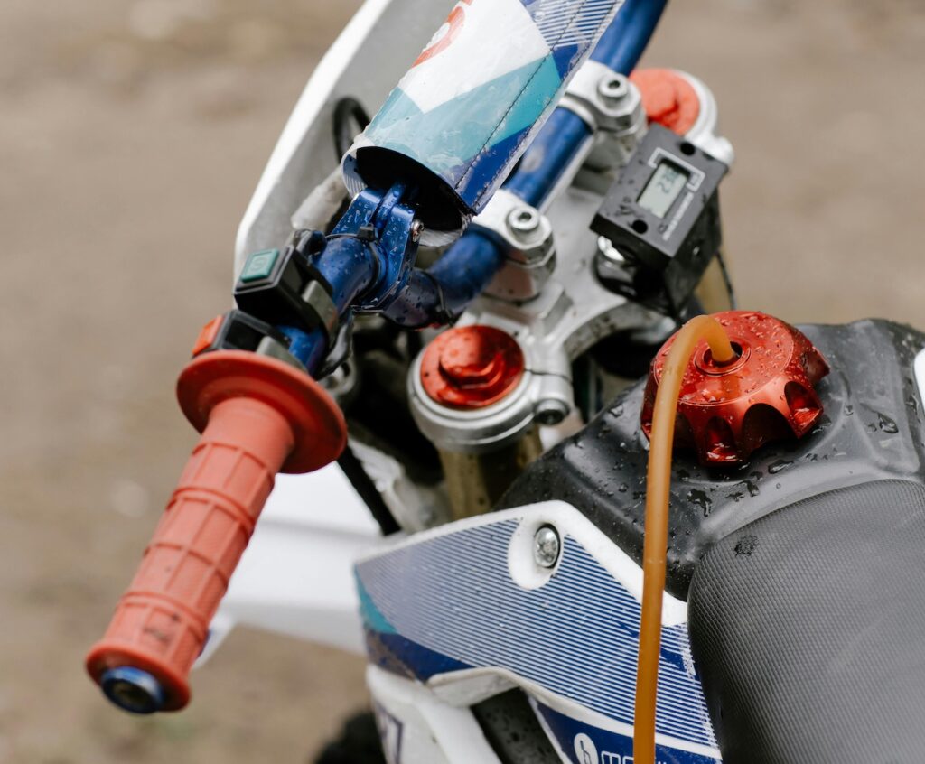 A dirt bike with some new motorcycle grips on the handlebars