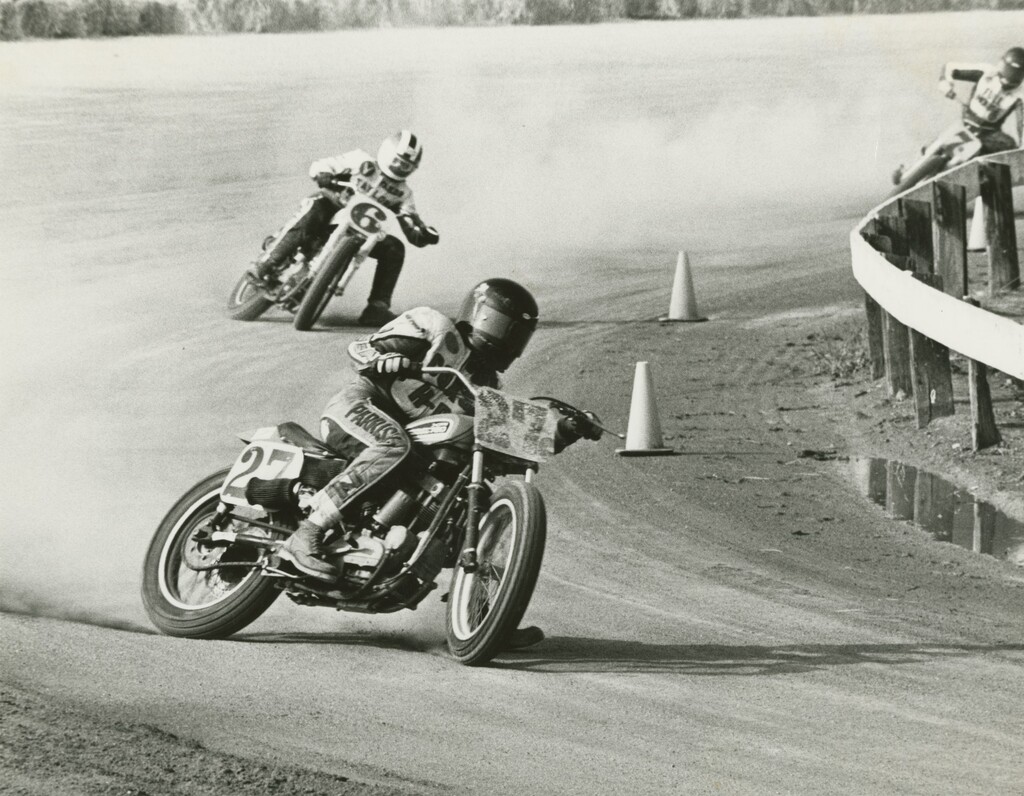 Harley-Davidson XR750 racing in a flat track race.