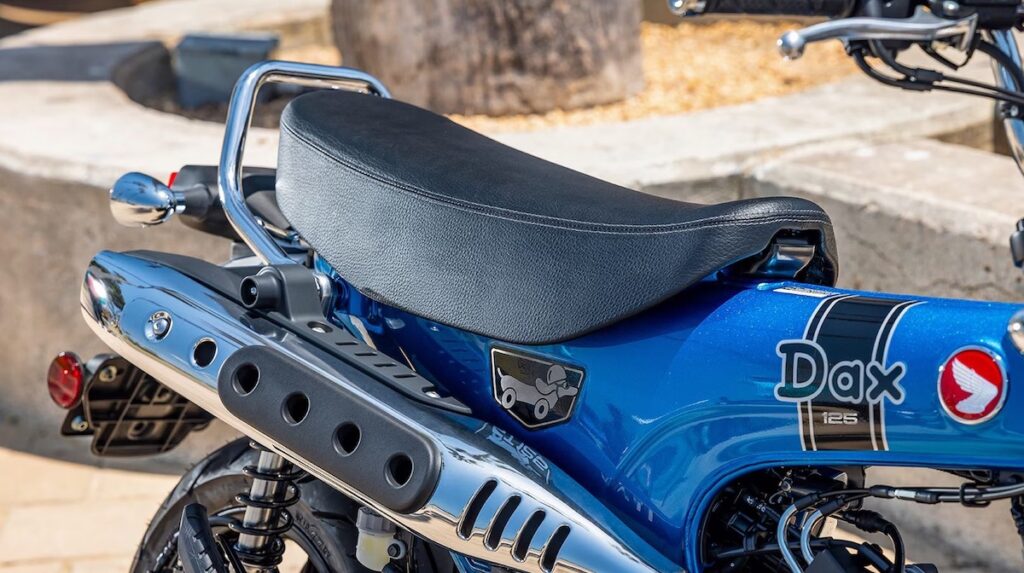 Close up of the Honda Dax 125 seat and exhaust pipe