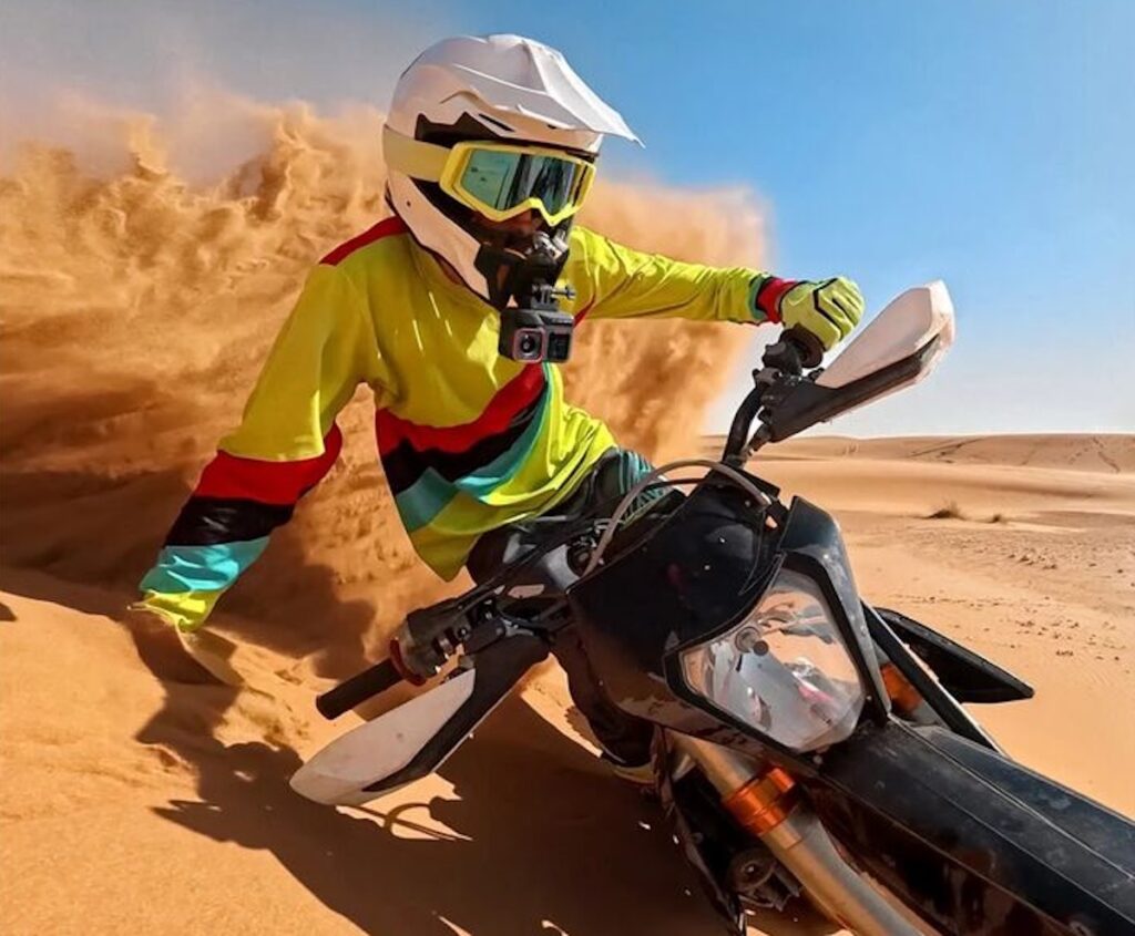A dirt bike rider wearing the Insta360 Ace Pro 2 Motorcycle Camera Bundle