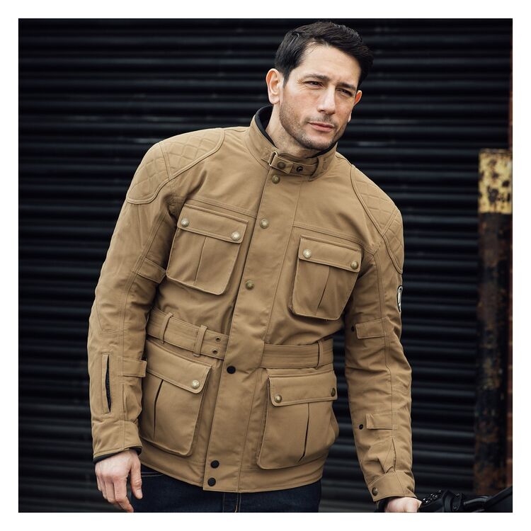 A motorcyclist wearing a Sand colored Merlin Burslem D30 Eco Laminated Jacket
