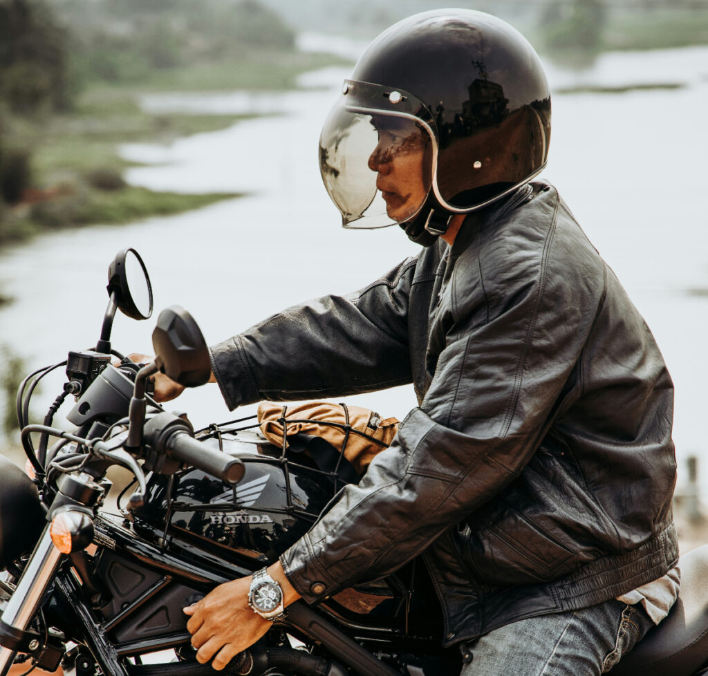Motorcyclist on a Honda wearing gear and a watch.