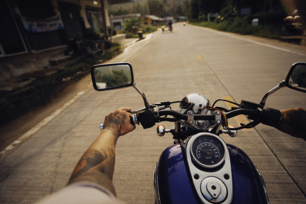 a motorcyclist riding down a road