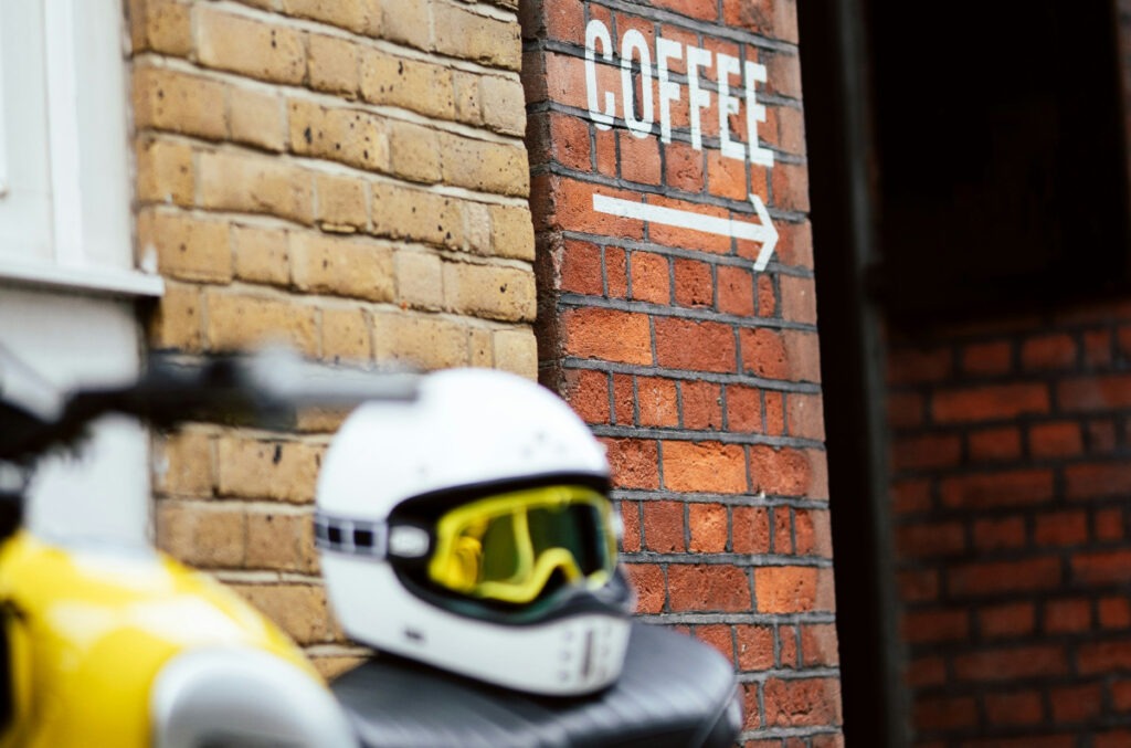 Motorcycle parked outside of a coffee shop