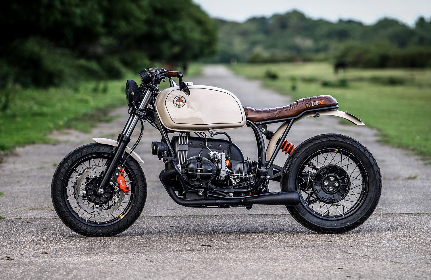 Custom BMW R100R street scrambler by Side Rock Cycles with satin black frame and orange rear shock spring